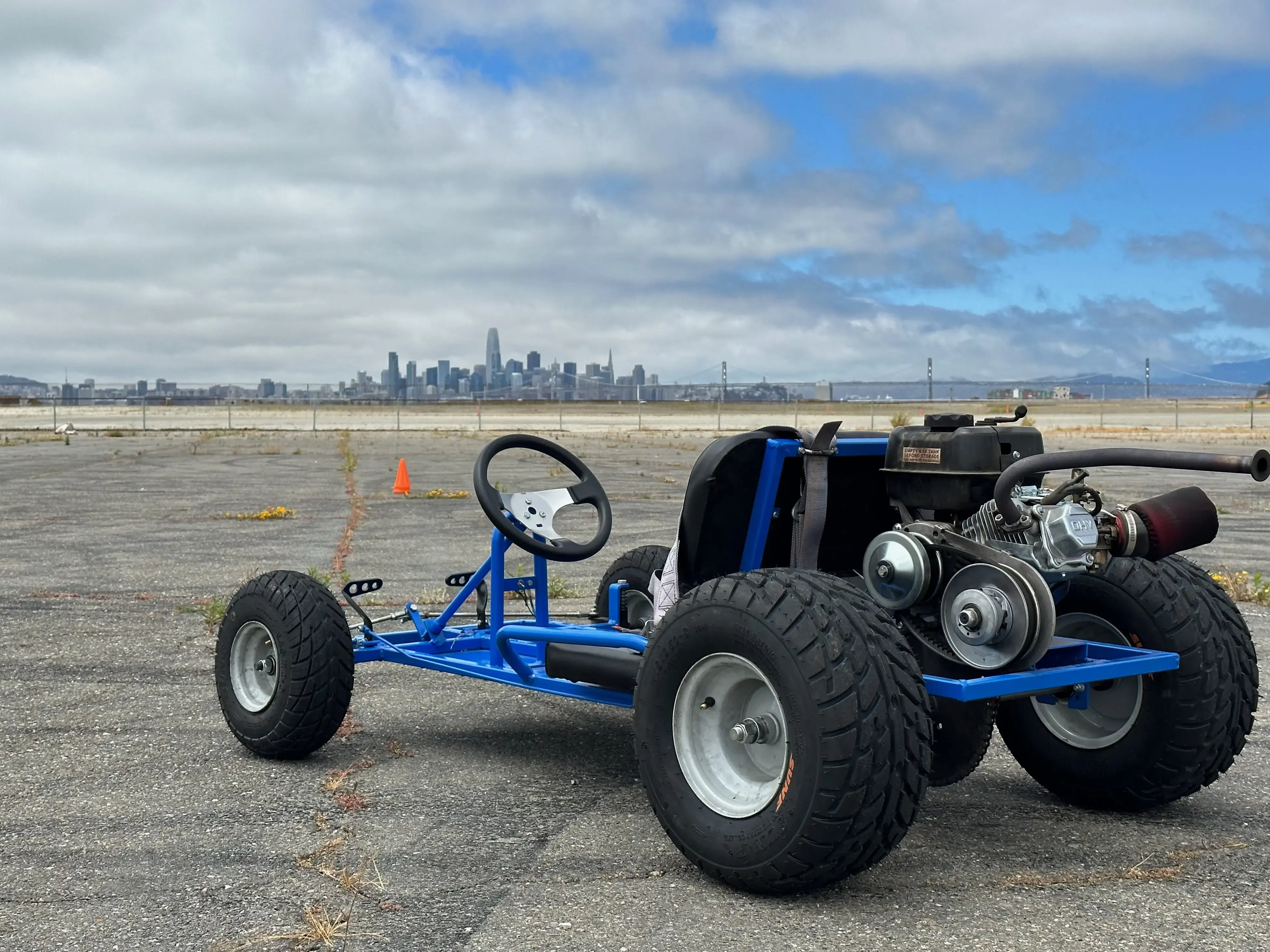 Image of blue Go-Kart in front of a city skyline